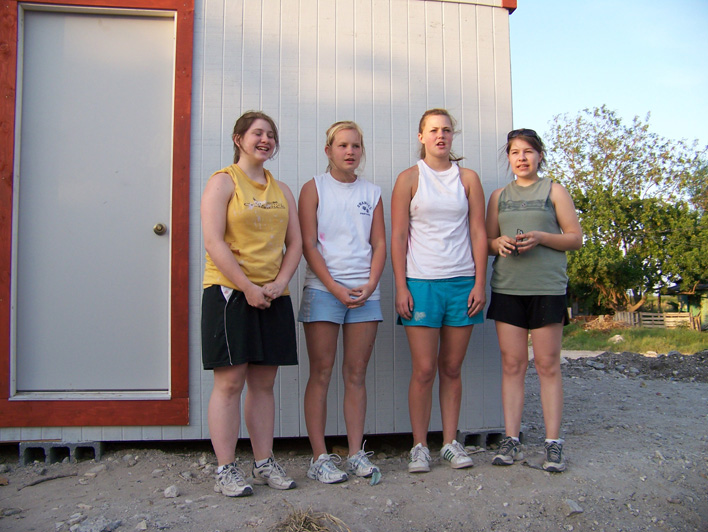 10 - Four team members singing at the dedication for Samuel and Leti